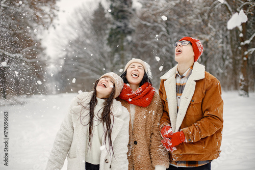 Teen siblings and their mother having fun at winter park