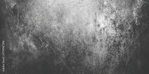 Grunge textured background in black and white with scratched and distressed cement wall effect.