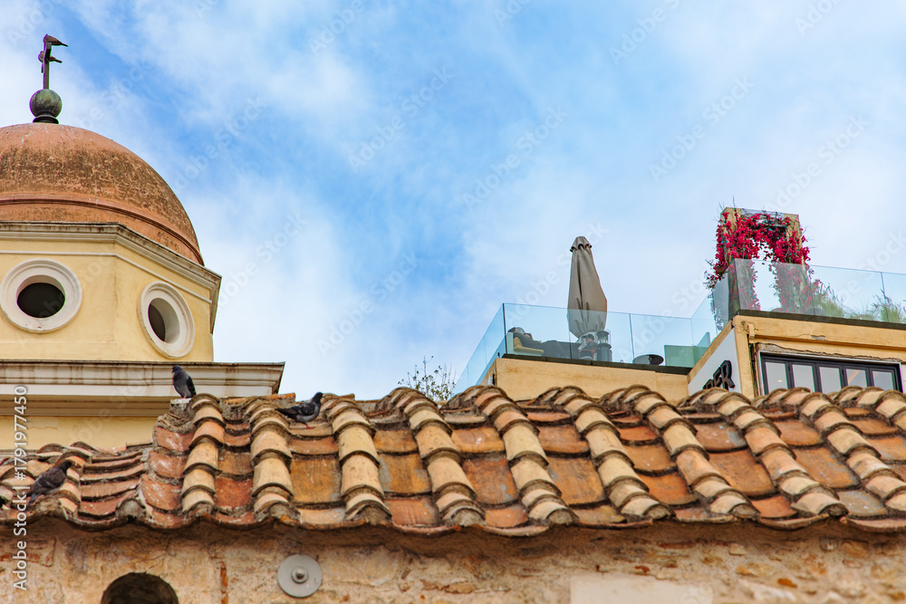 Naklejka premium Historic Pantanassa Church in Monastiraki Square, Athens, with pigeons on the old tiled roof. Ancient architecture, city life and Greek heritage