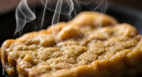 Close-up of golden-brown tofu puff with steam rising, perfect for culinary delights