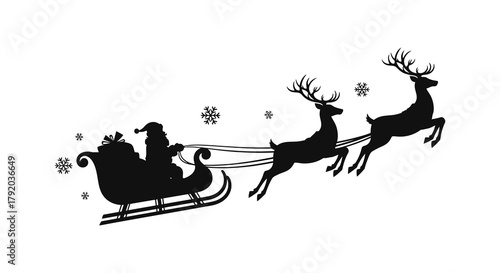 Silhouette of santa claus in a sleigh pulled by reindeer flying through the night sky with snowflakes