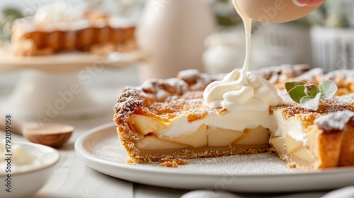 Crème fraîche being dolloped onto a slice of apple pie.