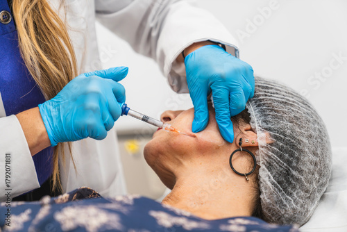 фотографія Woman getting a facial biostimulator injection to stimulate collagen production