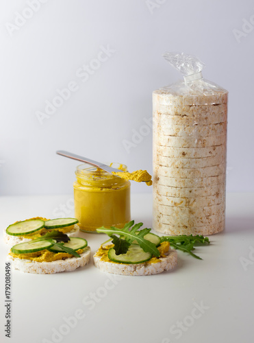 Crispy rice crackers package with spread and fresh cucumbers