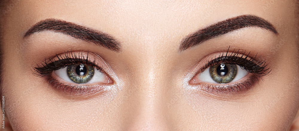 Obraz premium Beautiful female eyes with long eyelashes. Eyelash extensions. Makeup, cosmetics, beauty. Close up, macro
