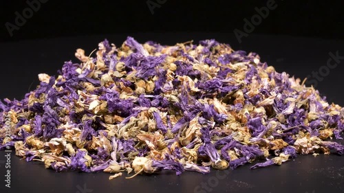 Close-up footage of dried hibiscus on black background.