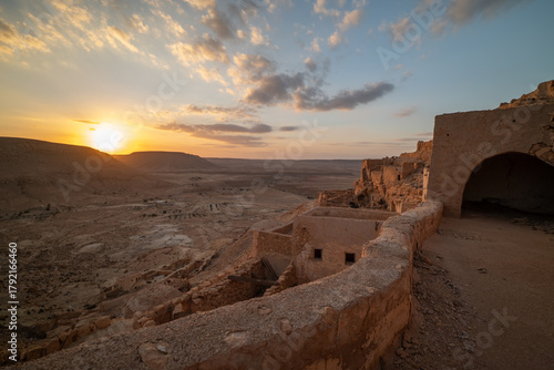 Guermessa rises among southern Tunisia’s hills, an ancient Berber village glowing in warm desert light at sunset