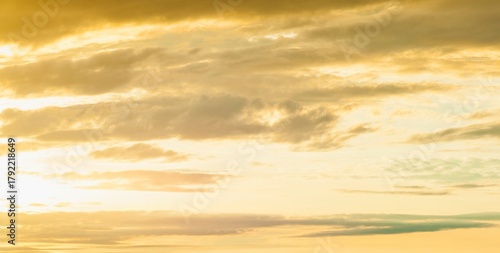 Golden hour sky with wispy clouds and horizon