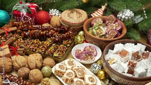 Beautiful and festive Christmas background with candies and sweets and decorations, Sweet food Turkish delight on wooden background, assorted locum and candy for decorated backdrop
