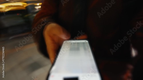 Person scrolling social media on smartphone at night
