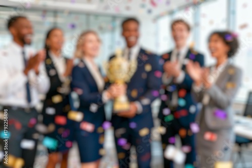 Blurred photo Portrait of happy smiling employees holding awards for success in business, standing in the office with their teammates applauding the company's best employee award.