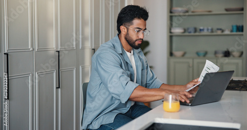 Wallpaper Mural Home, paperwork and man with laptop, typing and writer with royalty statement, filing or calculation. Creative, author and person with document for self employment tax, online and financial analysis Torontodigital.ca