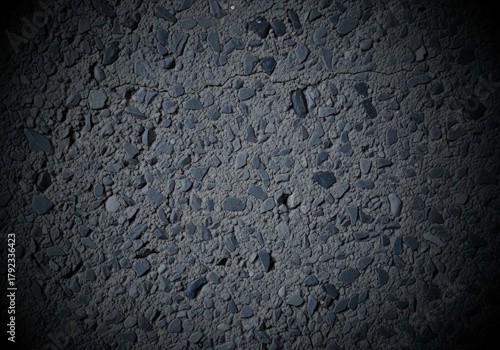 Fototapeta Naklejka Na Ścianę i Meble -  Close-up of dark asphalt road surface with small stones and cracks