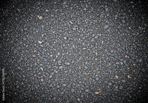 Fototapeta Naklejka Na Ścianę i Meble -  Close-up of asphalt road surface with small stones and dark texture