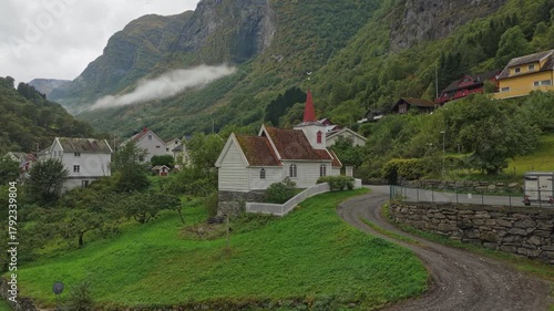 High-angle view of the tiny Undredal Stave Church surrounded by dramatic landscape, Norway