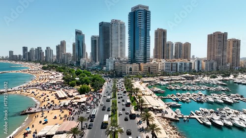 Aerial View of Cars Driving on Highway, Beach, Marina, and Skyscrapers in Kuwait City
