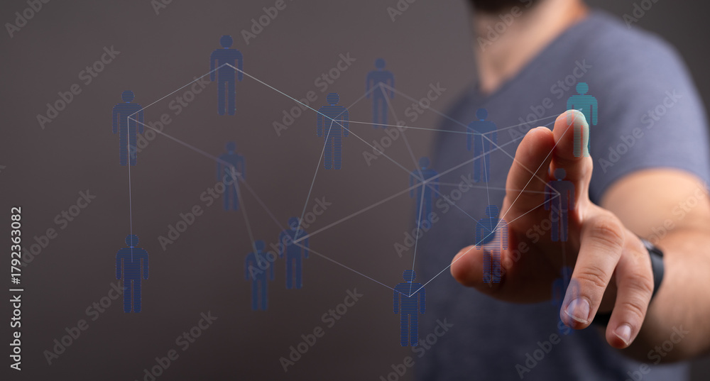 Fototapeta premium Concept of digital networking, connection, and social interaction, with a man touching a network.
