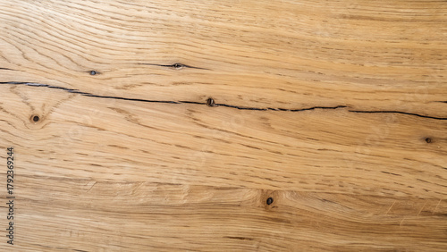 Fototapeta Naklejka Na Ścianę i Meble -  Close up of a light brown wooden surface with a crack running through it, showing the natural grain and texture of the wood