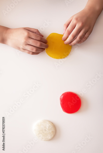 Vibrant slime play in a child’s hands. A joyful and creative sensory activity.