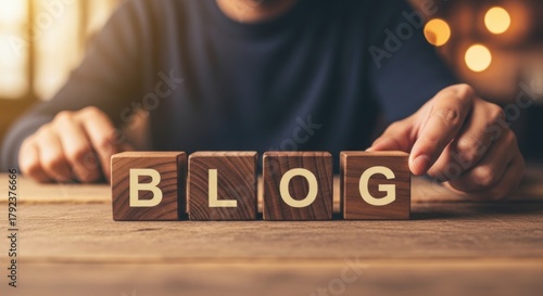 Wooden blocks spelling the word blog arranged on a wooden surface representing online content creation and digital communication