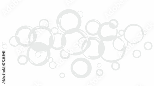 A scattered arrangement of translucent grey circular shapes on a white background