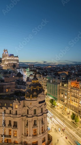 Dusk to night timelapse view of Madrid skyline and rush hour traffic on Gran Via street in Madrid, Spain.