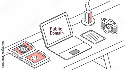 Creative workspace with open laptop, old camera, candle, book and notes