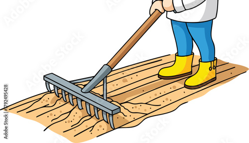 Person wearing yellow boots and blue jeans raking soil with a metal rake on a wooden surface