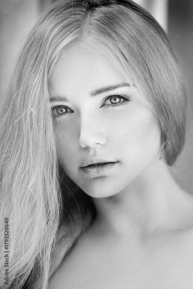 Naklejka premium Woman face close up. A pretty young blond trendy. Girl with a beauty face. Beautiful female face with luxury make-up