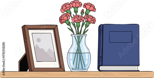 A still life composition of a framed photo, a vase with red flowers, and a closed blue journal on a wooden shelf, conveying a sense of tribute and memorial with a simple and elegant setup.