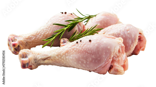 Raw chicken drumsticks with rosemary and peppercorns isolated on a transparent background