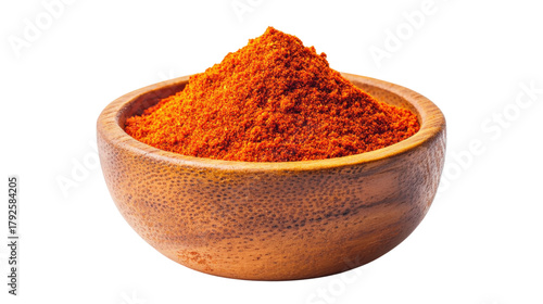 Red paprika powder in wooden bowl isolated on a transparent background