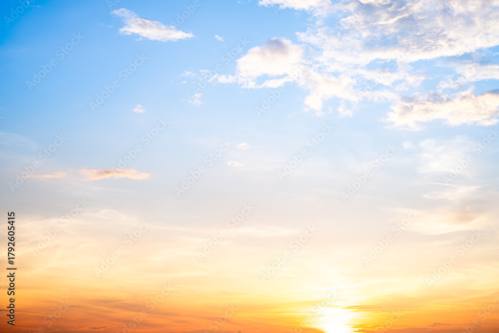 Obraz premium Beautiful , luxury soft gradient orange gold clouds and sunlight on the blue sky perfect for the background, take in evening,Twilight, Large size, high definition landscape photo