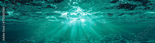 Close underwater view with shimmering aqua light, sun rays, crystal-clear water, and detailed caustics