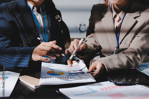 Close up high angle Asian businesswoman working with her coworker in meeting room