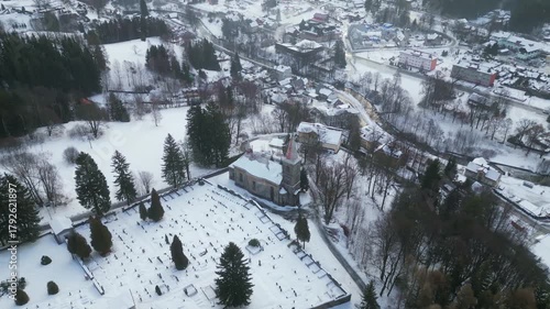 Explore the serene beauty of the Church of St. Peter and Paul in Tanvald during winter. Aerial views capture the church surrounded by snow and peaceful landscapes.