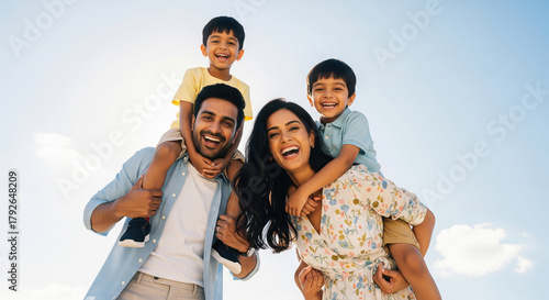 Happy Indian Family Enjoying Playful Outdoor Moment