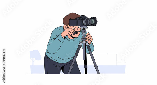 Photographer With Camera On Tripod Preparing To Take Photo