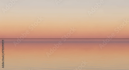 A serene and tranquil seascape at sunset, with a calm ocean reflecting the colorful sky.