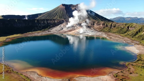 Aerial view of an active volcano with lake and steam plumes