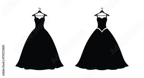 Silhouettes of elegant black evening gowns hanging on clothes hangers