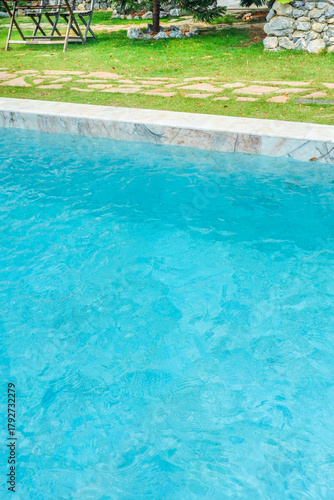 Empty swimming pool with sunbed and white umbrella in resort hotel for vacation leisure and white sand,resort neary sea and beach in summer.