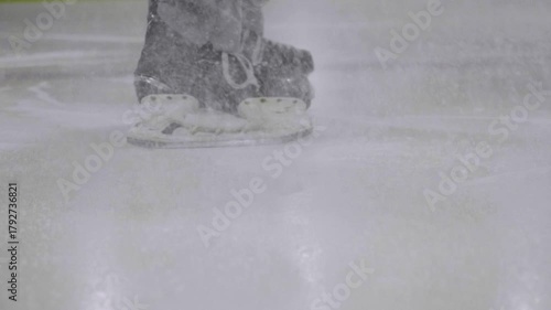 Ice Speed Skater Braking Hard Throwing Ice Toward Camera in Slow Motion