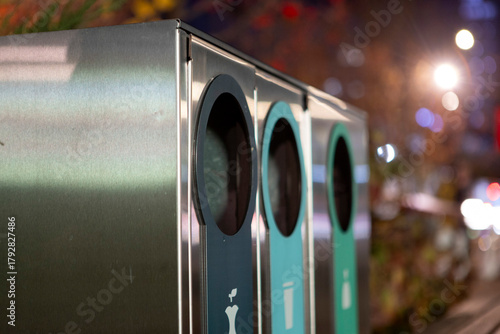 Modern glossy metal trash can. Waste sorting. Green concept.