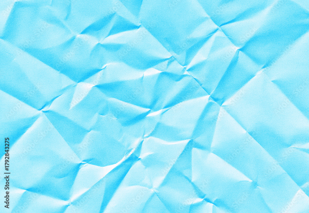 Obraz premium Blue crumpled paper background with soft folds, subtle shadows, and textured creases for versatile design use in presentations, banners, posters, web graphics, and branding layouts