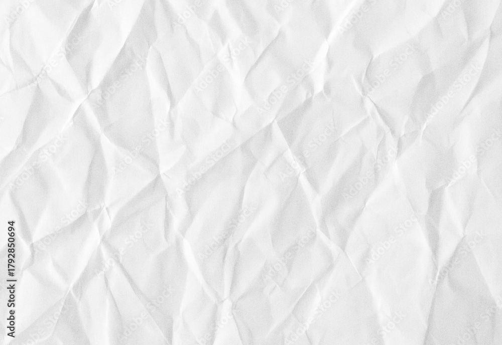 Fototapeta premium Close up of white crumpled paper texture with subtle shadows and irregular crease, ideal as a versatile background or design element for presentations, branding, and work
