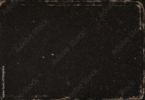 Macro shot of a rugged dark surface with subtle grain and worn edges, presenting a versatile texture that resembles leather, asphalt, or vintage film for creative design use