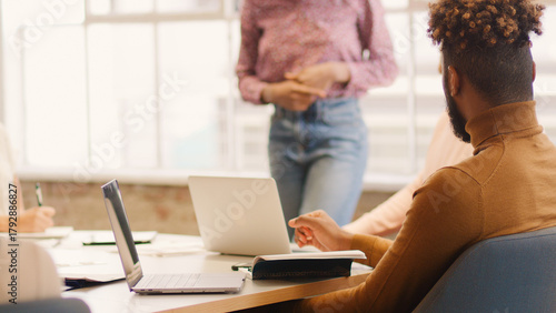 Close Up Of Young Multi Cultural Business Team Meeting Around Table In Modern Office