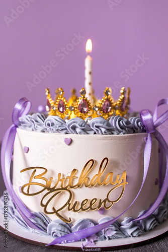 Birthday cake with candle and a crown. Cake with white icing and decor