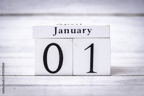 Handcrafted block calendar displaying January 01 on a textured wooden background. Ideal for representing new beginnings, celebrations, and annual events.